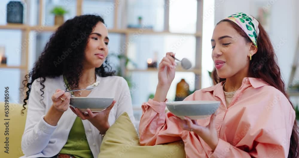 Poster Lesbian couple on sofa together, eating breakfast and laughing with fun, conversation and smile. Morning bonding, relax and happy lgbt women on couch in home living room, funny talking and food bowl.