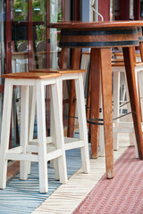 Stools and table on the terrace of a bar