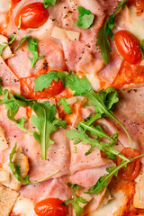 Appetizing wallpaper with italian meaty pizza decorated with arugula, halved cherry tomatoes and pineapple