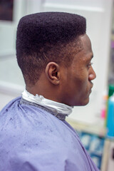 portrait of person in a barber shop who just got their haircut