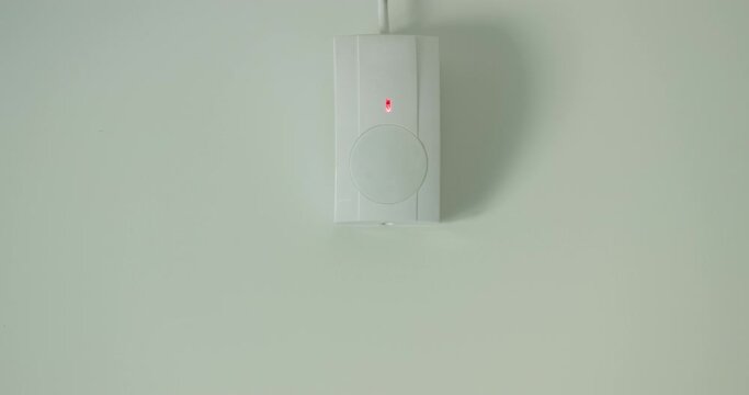 The motion sensor alarm is triggered. The red LED on the sensor lights up