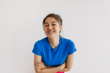 Close up of happy asian woman in blue t-shirt isolated on white.