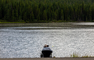 Unrecognizable fisherman on Echo Lake in the Rocky Mountains, Colorado