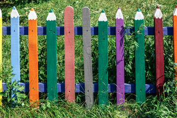 Colored wooden fence in the form of pencils