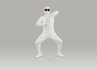 Funny man in bodysuit. Full length shot of happy young man disguised in white spandex fancy dress Halloween party body suit costume and black round sunglasses dancing on gray studio background
