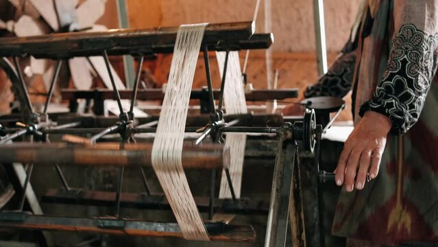 Traditional silk production. Processing Boiling silkworm cocoons in hot water. The process of producing silk by hand closeup from Cocoon to Silk thread