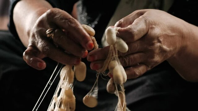 Boiling silkworm cocoons by boiler to make silk thread. Traditional silk production. Silk worms being separated from cocoons in silk factory