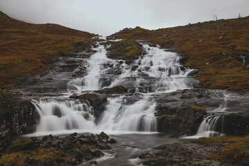 beautiful waterfall in the mountains of Faroe islands - 635212793