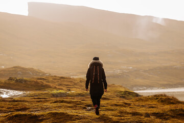 Hiker walking on a trail in Faroe islands - 635212900