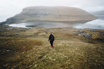 Hiker in the nordic landscape of faroe islands - 635212945