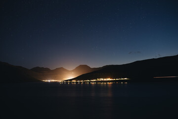 long exposure shot of a mountain village in faroe islands at night with sky full of stars - 635212964