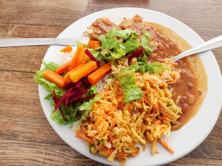 Typical colorful Brazilian meal called Prato Feito, using typical ingredients like salpicão (Brazilian salad) on the wooden table