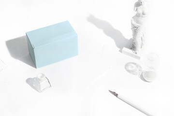 Composition with tea boxes, classic sculpture, writing pen and ink