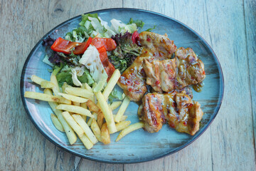  grilled chicken and french fries on a plate 