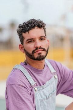 Serious young bearded man looking at camera