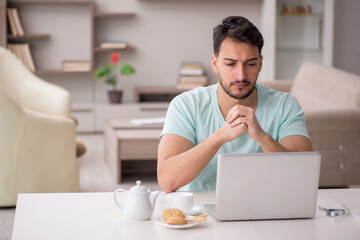 Young male freelancer working from home