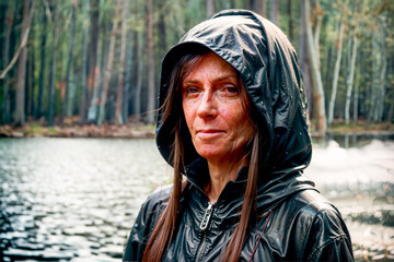 Old worn out woman standing in lake shore. Generative AI.