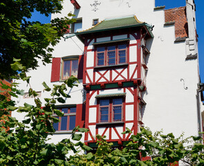 Fototapeta na wymiar Beautiful traditional German historic white half-timbered houses (also timber-framed houses) in Ulm City, Germany 