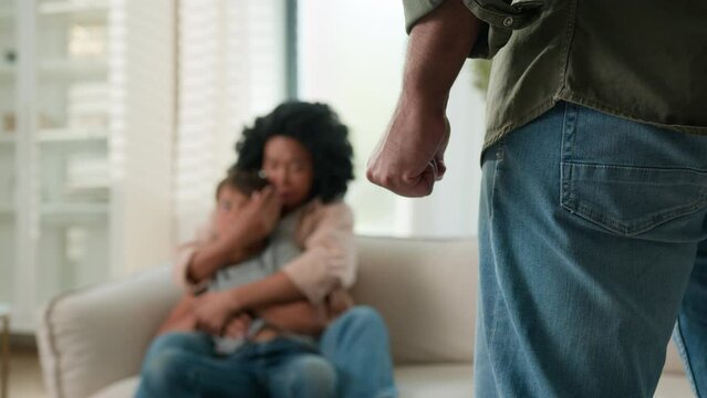 Domestic physical violence in family abuse agressive man with clenched fist threaten to hit scared woman wife hide little boy son child from husband attack feel fear threat parents conflict home fight
