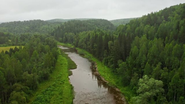 Aerial view of beautiful river among green forest. Inzer river in Beloretsk district of Bashkortostan.