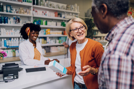 Portrait of a diverse senior couple buying medication in a pharmacy together
