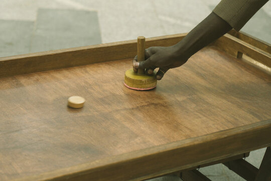 African teenagers play air hockey on the street, close-up of hands
