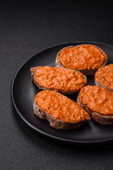 Delicious sandwich consisting of toast, red sauce with salt, spices and herbs