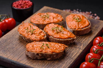 Delicious sandwich consisting of toast, red sauce with salt, spices and herbs