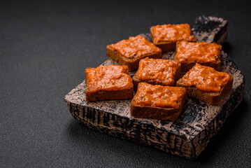 Delicious sandwich consisting of toast, red sauce with salt, spices and herbs