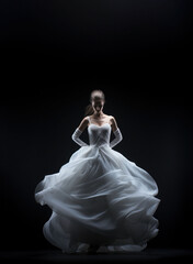 Fototapeta na wymiar Movement Art: Elegant Ballerina on a Dark Background