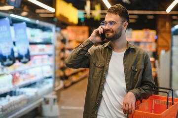 Handsome man shopping in a supermarket