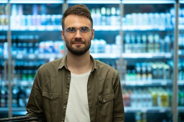 Fototapeta premium Handsome man shopping in a supermarket