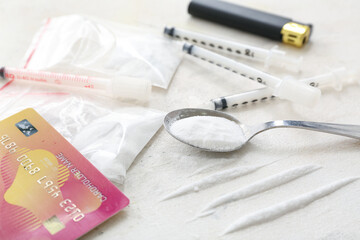 Composition with drugs, syringes and credit card on light background