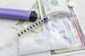 Plastic bag with drugs, syringe, lighter and money on light background, closeup