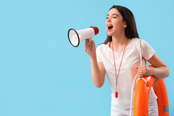 Female lifeguard with ring buoy shouting into megaphone on blue background