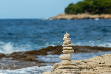 Fototapeta na wymiar Pyramid stacked stone on seaside