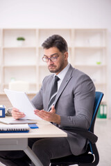 Fototapeta premium Young male employee working in the office