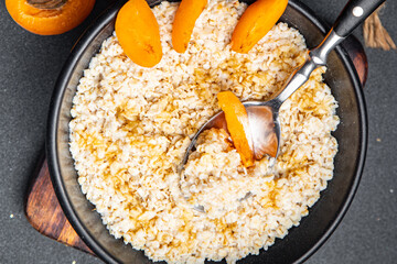 breakfast porridge oatmea fresh apricot tasty healthy meal food snack on the table copy space food background rustic top view