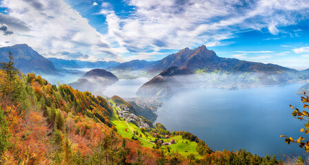 Fabulous autumn view of Stansstad city and Lucerne lake with mountaines and fog.