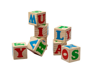 Children's wooden cubes with blue, red and green letters in the shape of a tower stand one on top of the other and lie side by side. No background. High quality photo.