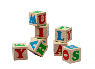 Children's wooden cubes with blue, red and green letters in the shape of a tower stand one on top of the other and lie side by side. No background. High quality photo.