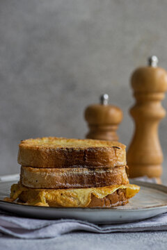 Slices of fried bread with egg coating on ceramic plate