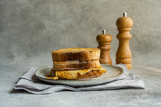 Slices of fried bread with egg coating on ceramic plate