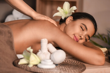 Fototapeta na wymiar Beautiful woman receiving spa massage in salon