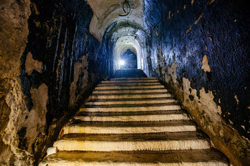 Old vaulted corridor of Soviet bunker, echo of Cold War