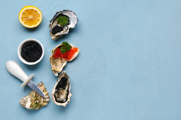 Tasty oysters with lemon, black and red caviar on blue background