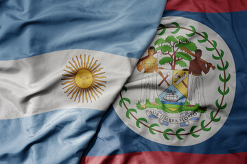 Obraz na płótnie Canvas big waving realistic national colorful flag of argentina and national flag of belize .