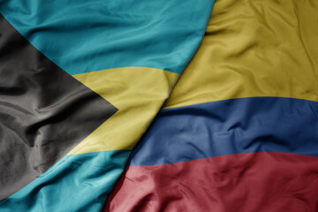 big waving realistic national colorful flag of bahamas and national flag of colombia .