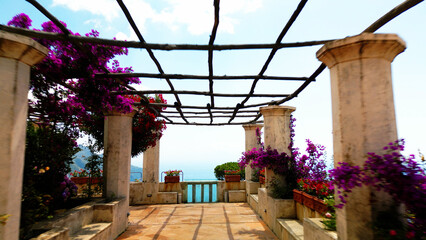 View of garden in villa Rufolo, ancient arhitecture in Ravello, Italy with pink flowers