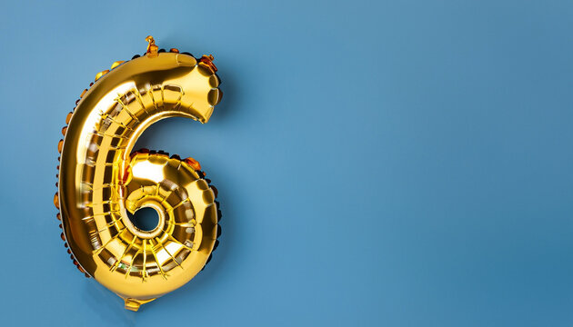 Banner with number 6 golden balloon with copy space. 6 years anniversary celebration concept on a blue background.